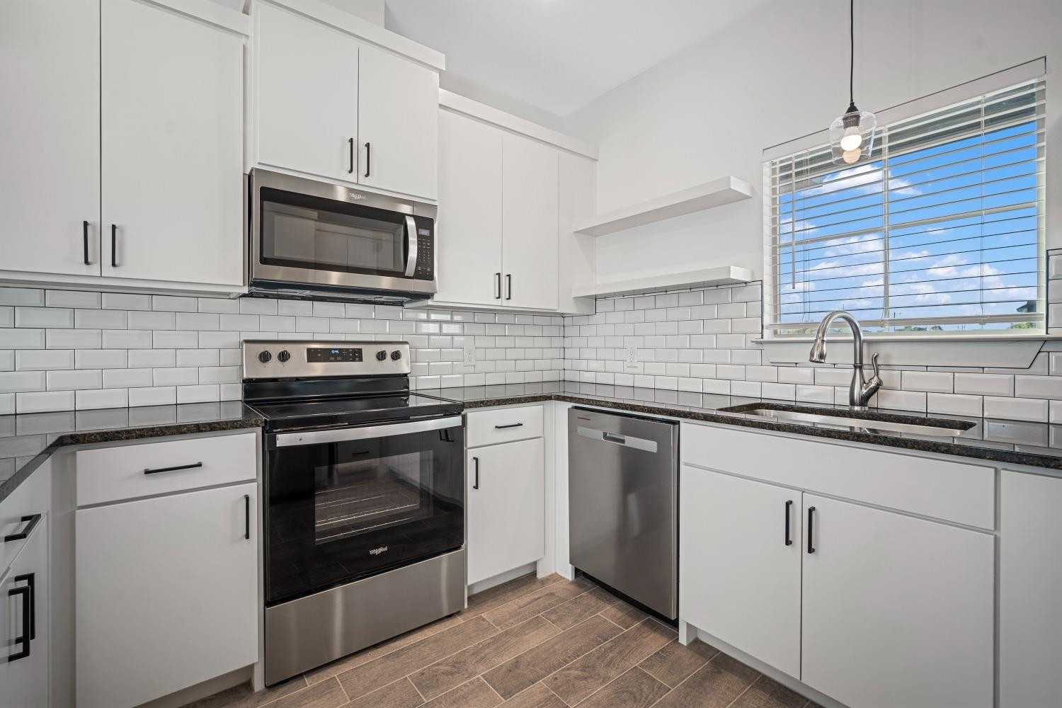 5902 Grinnell Street Lubbock, TX 79416 - Photo 10 of 26 a kitchen with white cabinets appliances and a sink