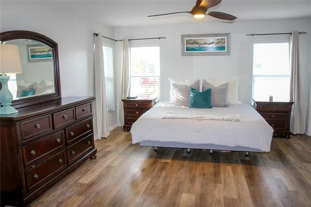 a bedroom with a bed and wooden floor