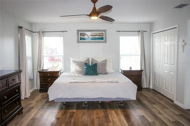 a spacious bedroom with a bed and a window