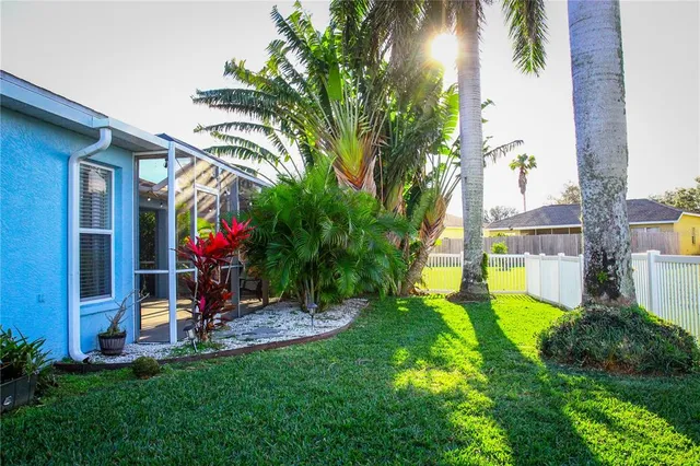 a view of a backyard with a table and chairs and potted plants