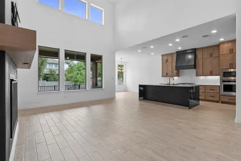 a view of an empty room with a fireplace and a window