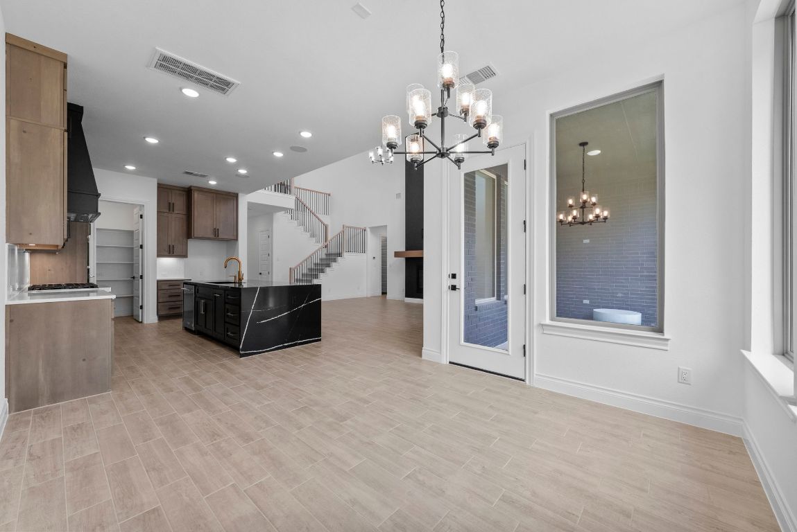 109 Strawberry Lane Georgetown, TX 78628 - Photo 20 of 40 a view of a big room with chandelier and windows