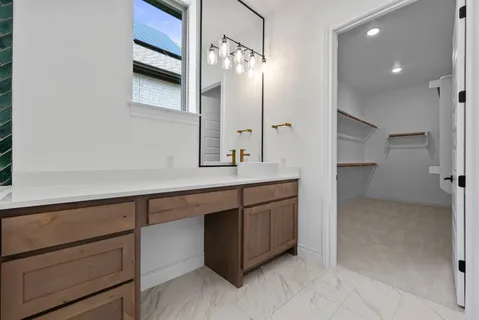 a bathroom with a double vanity sink a toilet a mirror and shower