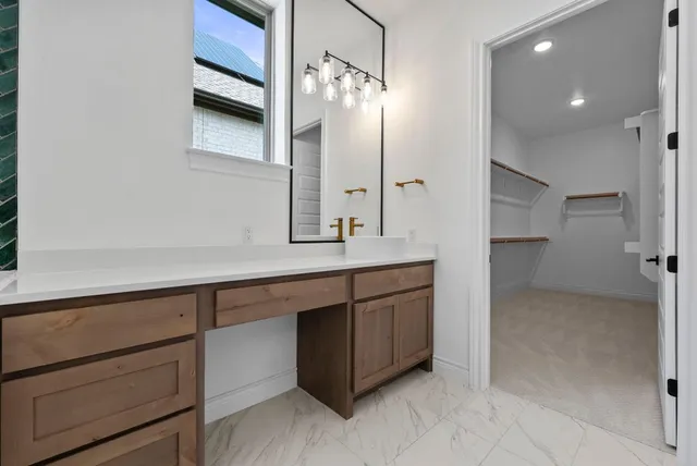 a bathroom with a double vanity sink a toilet a mirror and shower