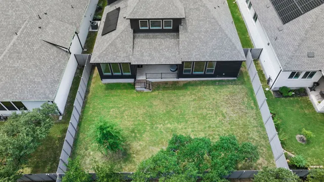 an aerial view of a house with swimming pool and mountains