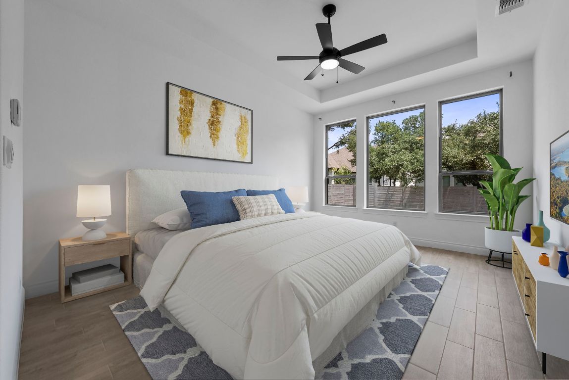 109 Strawberry Lane Georgetown, TX 78628 - Photo 5 of 40 a spacious bedroom with a bed a window and a chandelier
