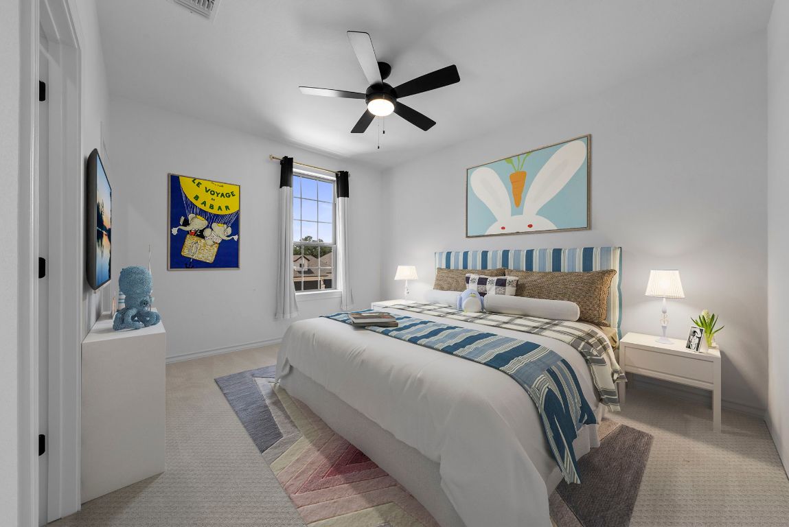 109 Strawberry Lane Georgetown, TX 78628 - Photo 6 of 40 a bedroom with a bed and a chandelier