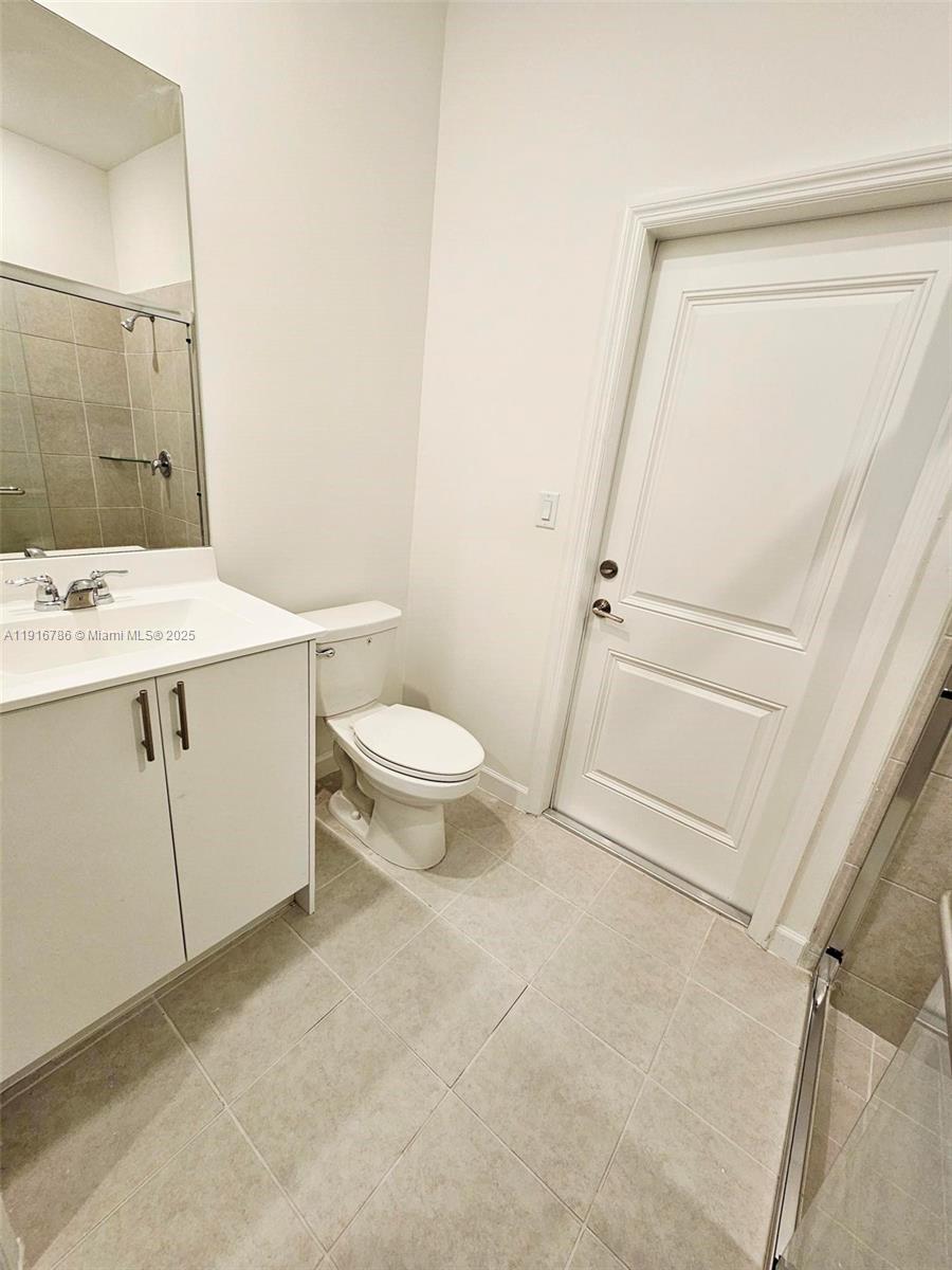 16233 Southwest 147th Place, Unit STUDIO Miami, FL 33193 - Photo 7 of 7 a bathroom with a sink a toilet a mirror and shower
