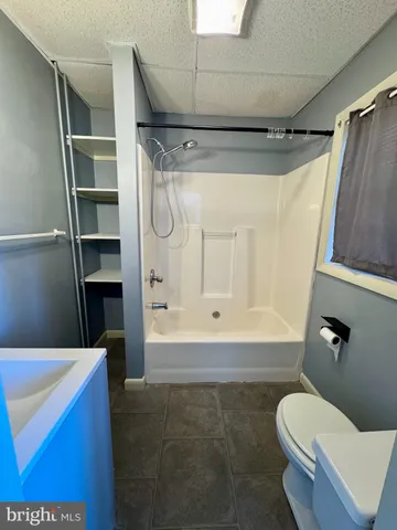 a bathroom with a toilet and a shower