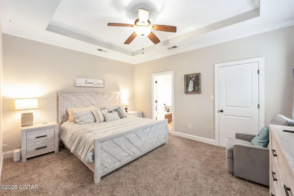 a bedroom with a bed and a ceiling fan