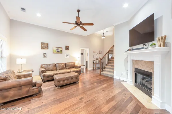 a living room with furniture a flat screen tv and a fireplace