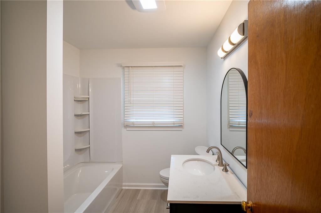 67 Dixie Park Drive Northwest Rome, GA 30165 - Photo 16 of 27 a bathroom with a tub sink and mirror