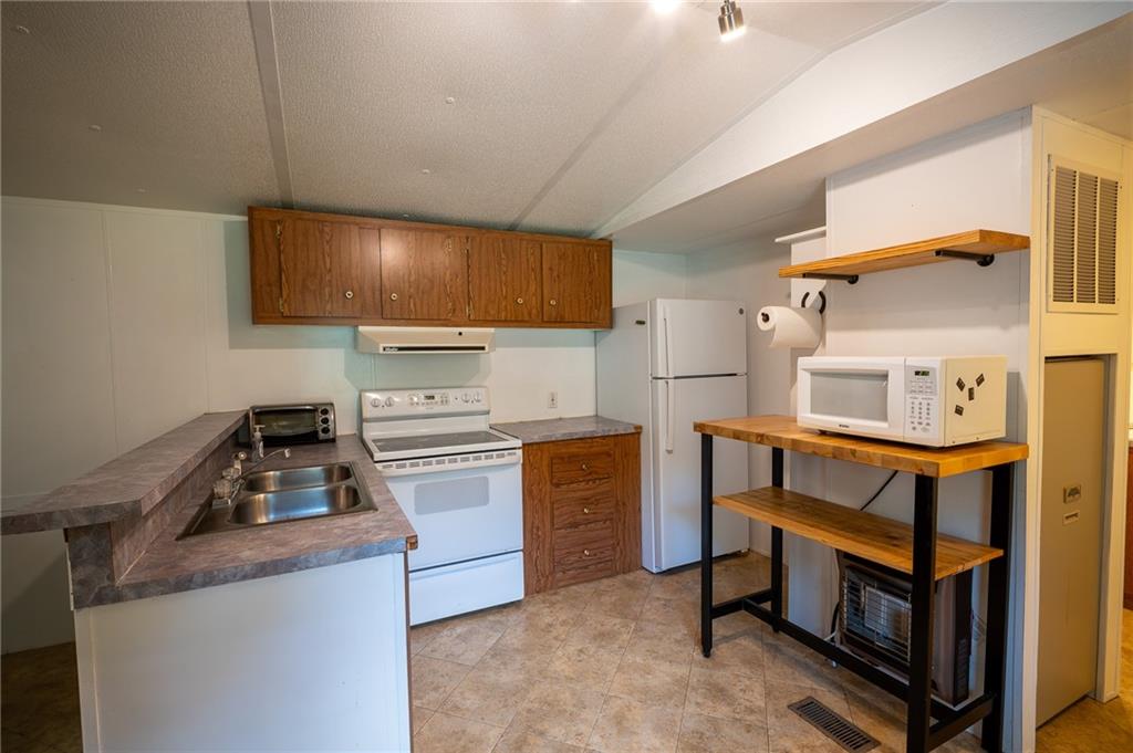 67 Dixie Park Drive Northwest Rome, GA 30165 - Photo 20 of 27 a kitchen with appliances cabinets and a sink