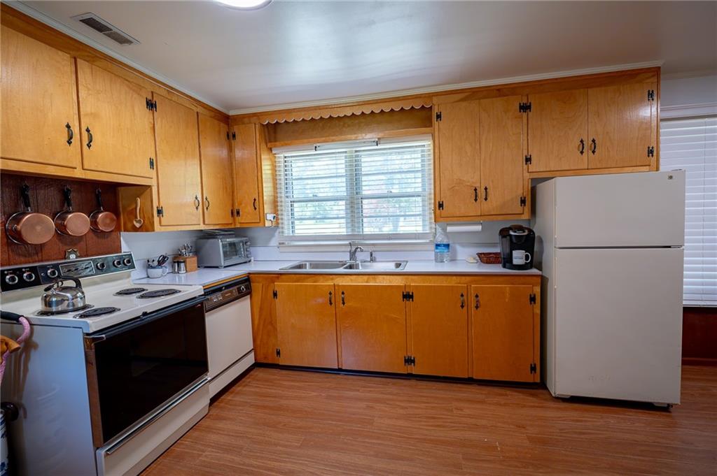 67 Dixie Park Drive Northwest Rome, GA 30165 - Photo 8 of 27 a kitchen with stainless steel appliances granite countertop a refrigerator a stove a sink and a microwave