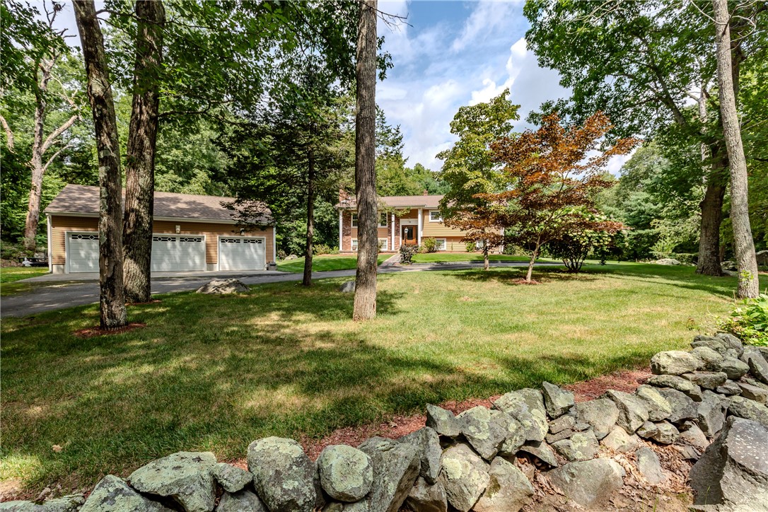 99 Tower Hill Road Cumberland, RI 02864 - Photo 5 of 43 Beautiful distant view showcasing the home, spacious three-car garage, and elegant circular driveway.