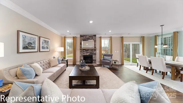 a living room with furniture large window and a table