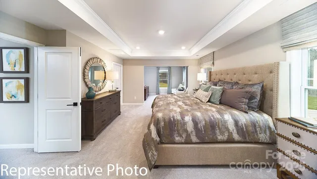 a bedroom with a bed and a view of kitchen