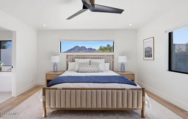 a bedroom with a bed and a painting on the wall