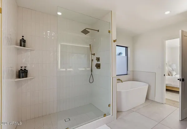 a bath room with a bath tub and a shower