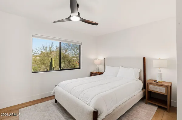 a bedroom with a bed and a painting on the wall
