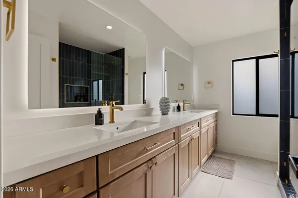 a bathroom with a double vanity sink and a mirror
