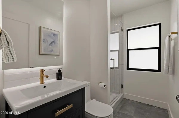 a bathroom with a sink mirror and toilet