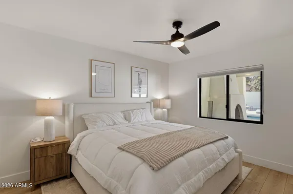 a bedroom with a bed and a painting on the wall