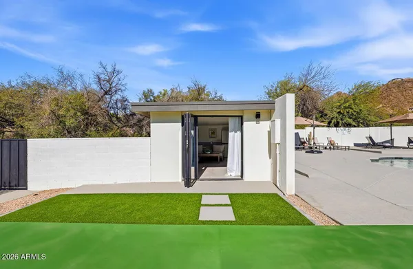 a view of house with backyard and outdoor seating