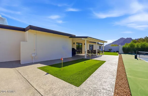 a view of house with swimming pool yard