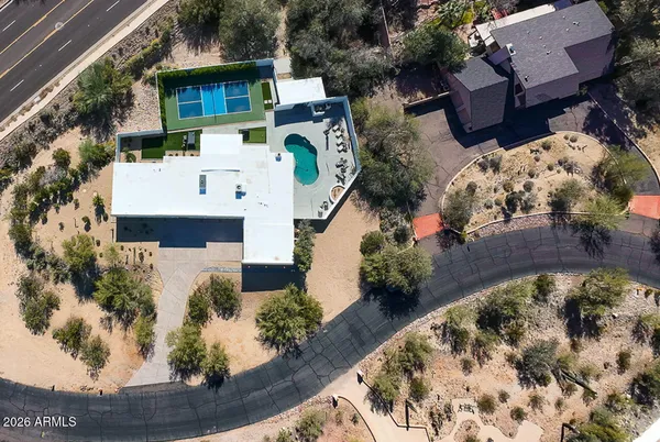 an aerial view of a house with a yard