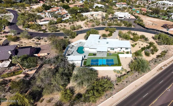 an aerial view of residential houses with yard