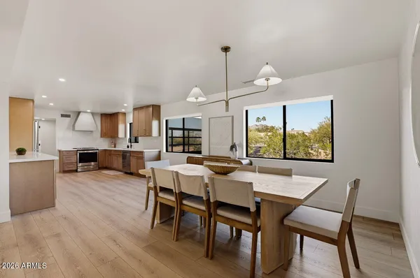a view of a dining room with furniture and wooden floor