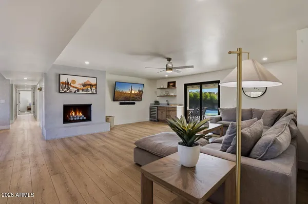 a living room with furniture fireplace and flat screen tv