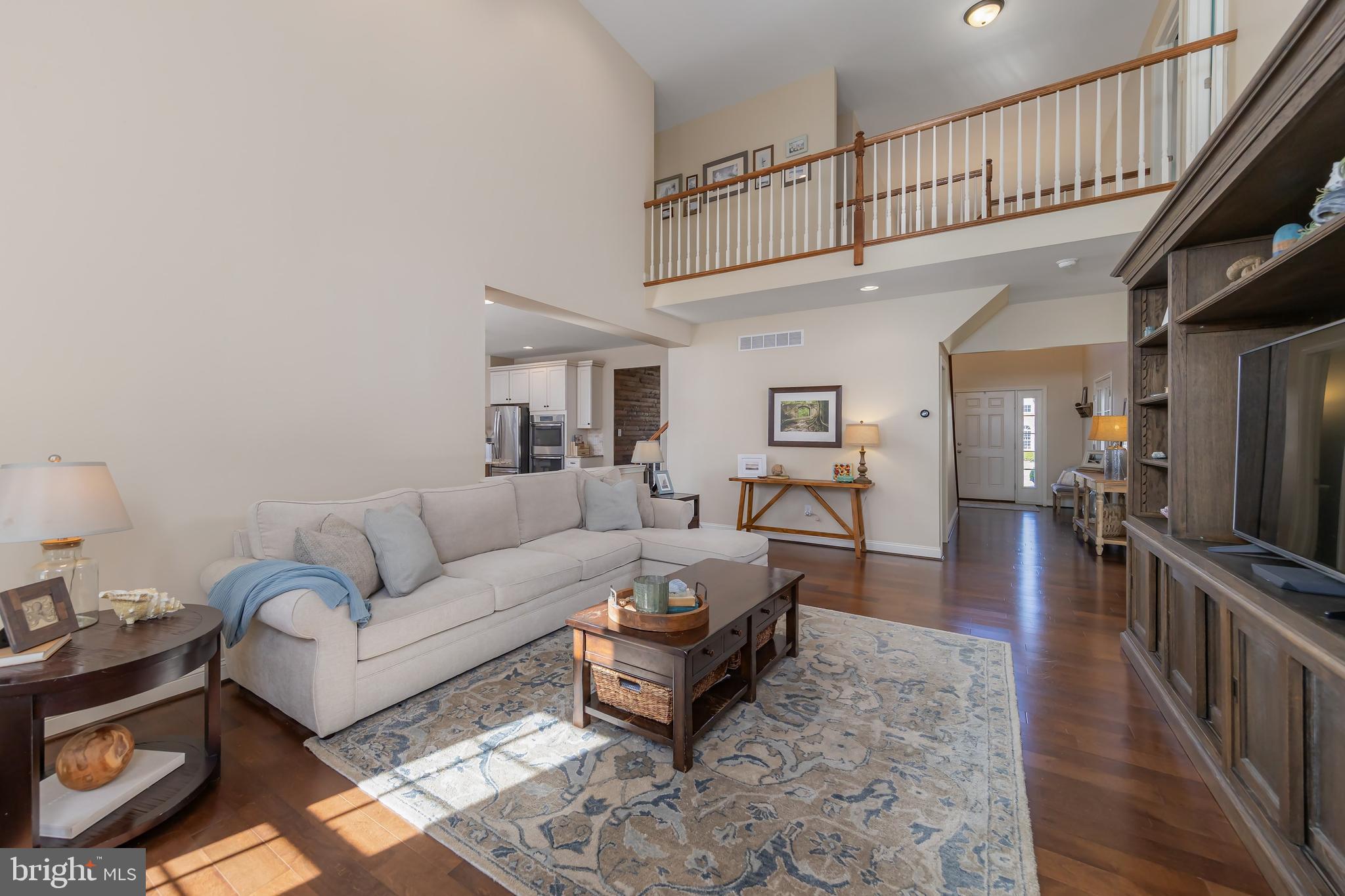 112 Robert Botto Way Clarksboro, NJ 08020 - Photo 15 of 60 a living room with furniture a wooden floor and a chandelier