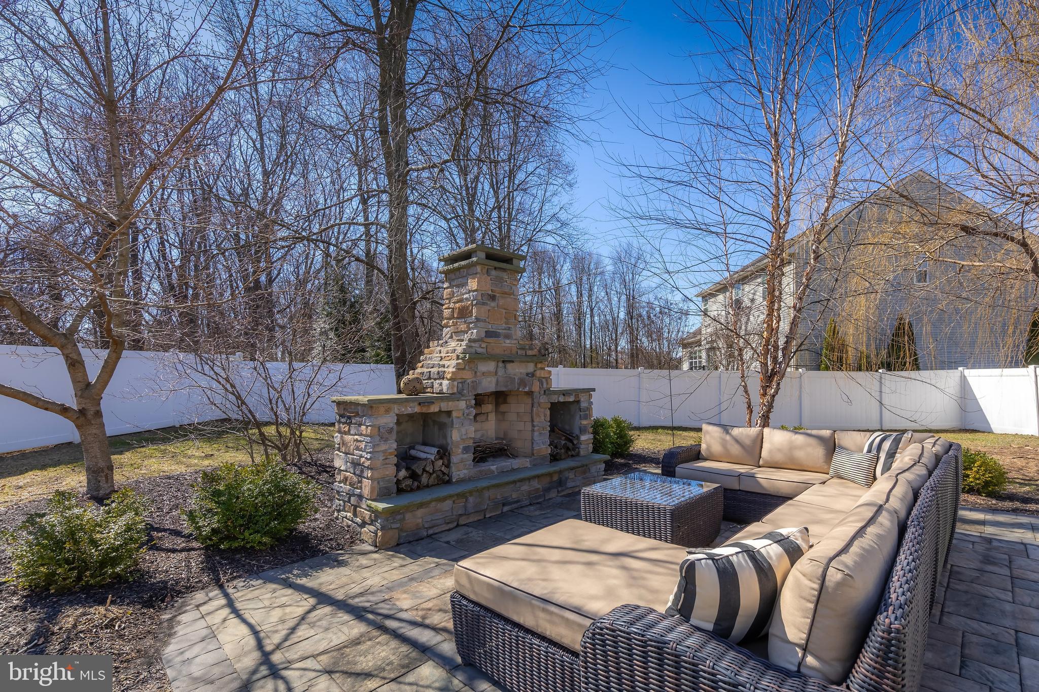 112 Robert Botto Way Clarksboro, NJ 08020 - Photo 39 of 60 a view of a patio with couches table and chairs under an umbrella with a fire pit