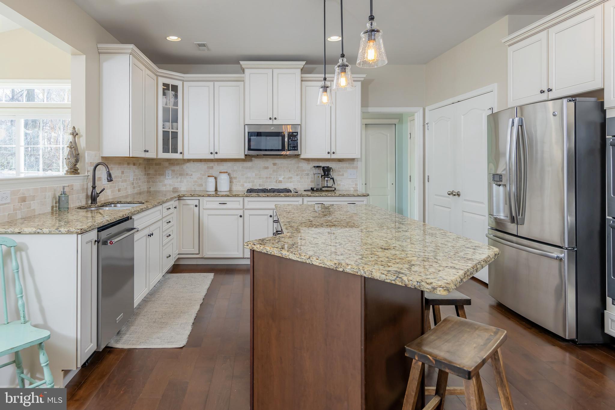 112 Robert Botto Way Clarksboro, NJ 08020 - Photo 7 of 60 a kitchen with kitchen island granite countertop a sink a center island and stainless steel appliances