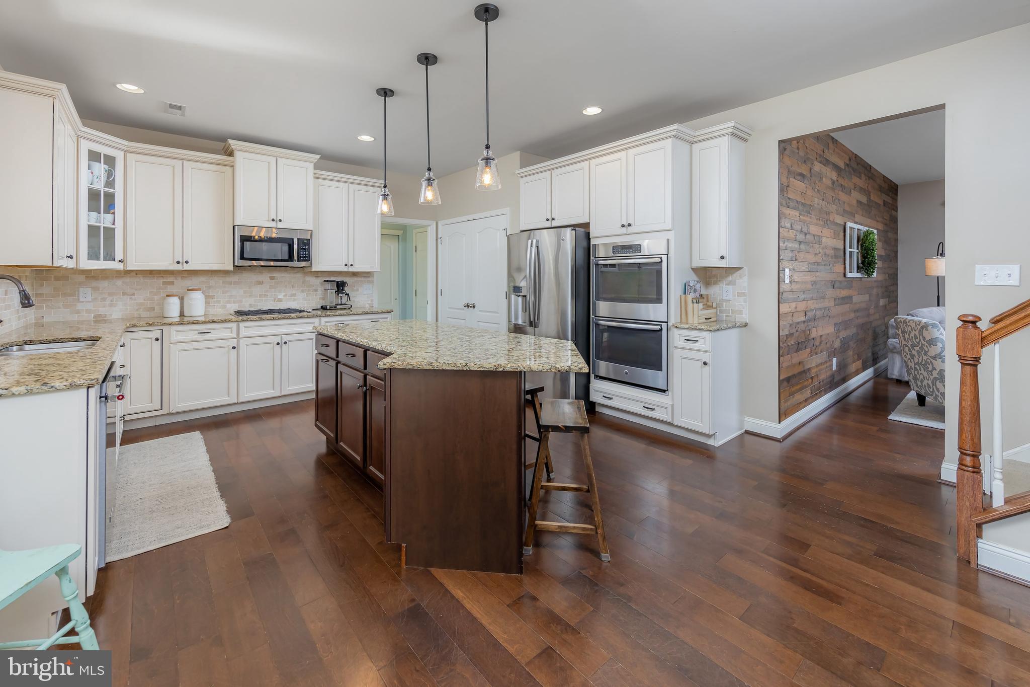 112 Robert Botto Way Clarksboro, NJ 08020 - Photo 8 of 60 a large kitchen with cabinets wooden floor stainless steel appliances and a center island