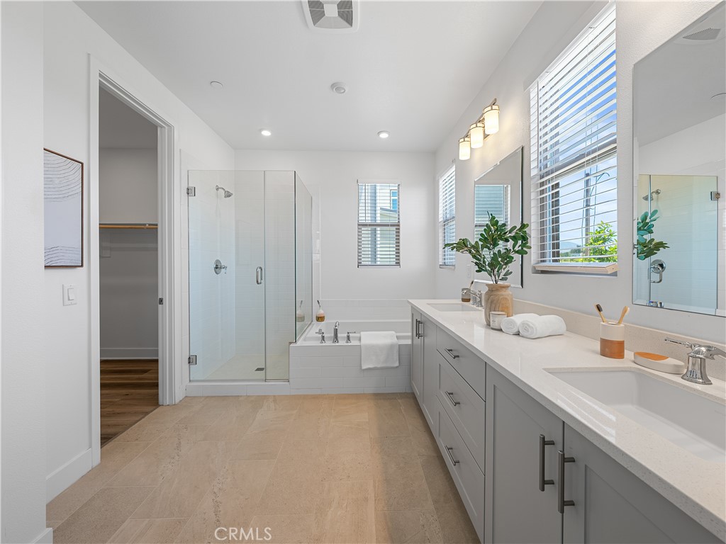 191 Lynx Irvine, CA 92618 - Photo 19 of 26 a spacious bathroom with a double vanity sink a large mirror and shower