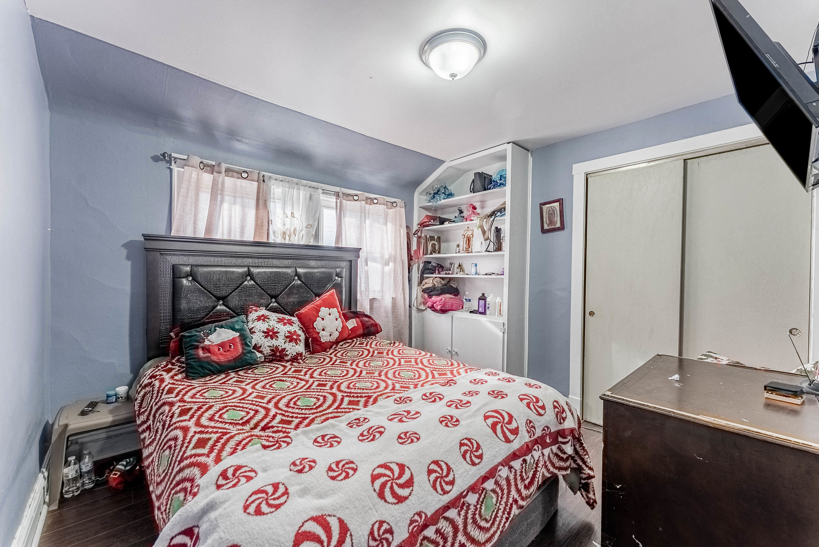 6933 South Michigan Avenue Chicago, IL 60637 - Photo 17 of 29 a bedroom with a large bed and a chandelier