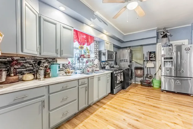a kitchen with stainless steel appliances granite countertop a stove cabinets and wooden floor