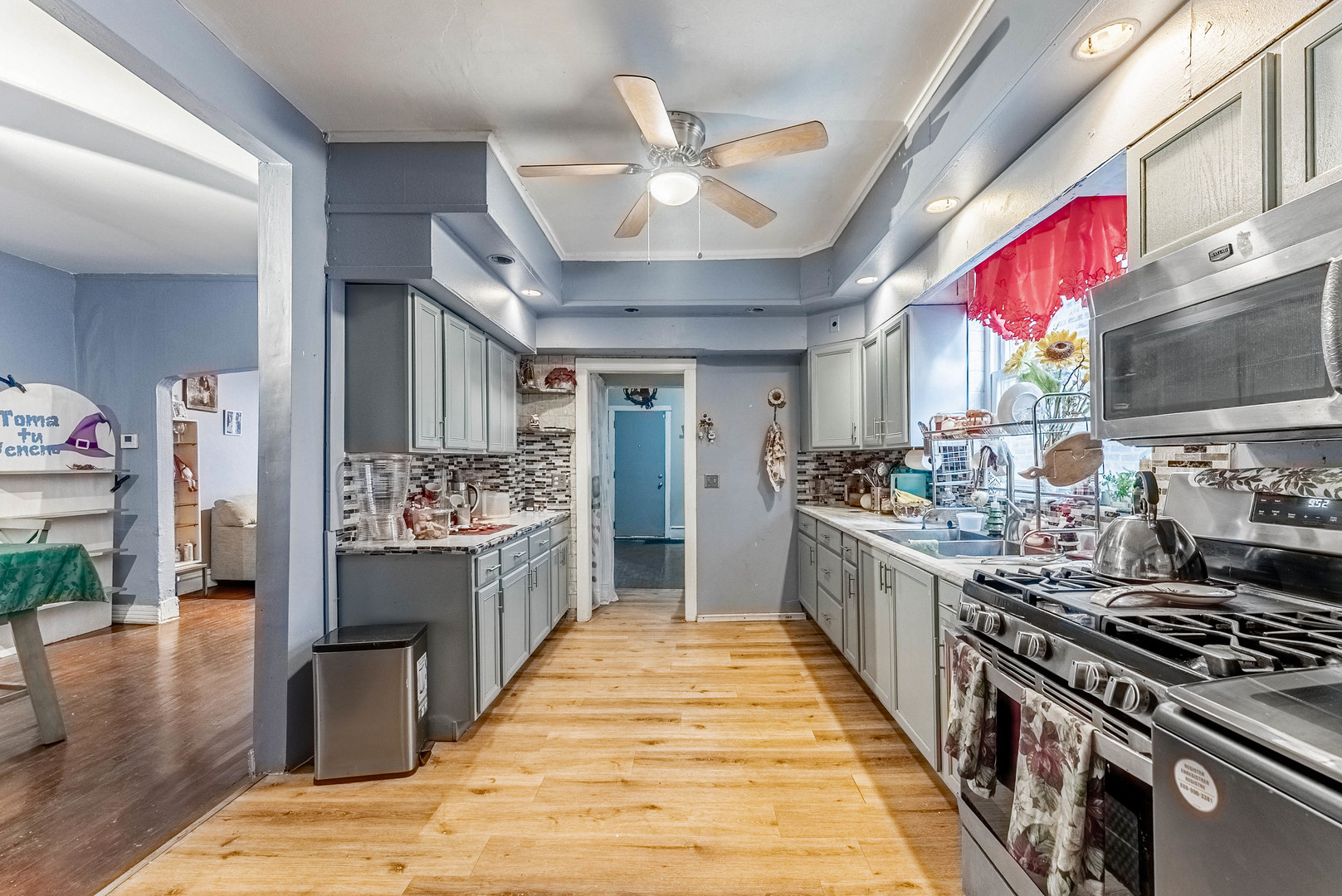 6933 South Michigan Avenue Chicago, IL 60637 - Photo 10 of 29 a kitchen with stainless steel appliances kitchen island granite countertop a stove a sink dishwasher and a refrigerator