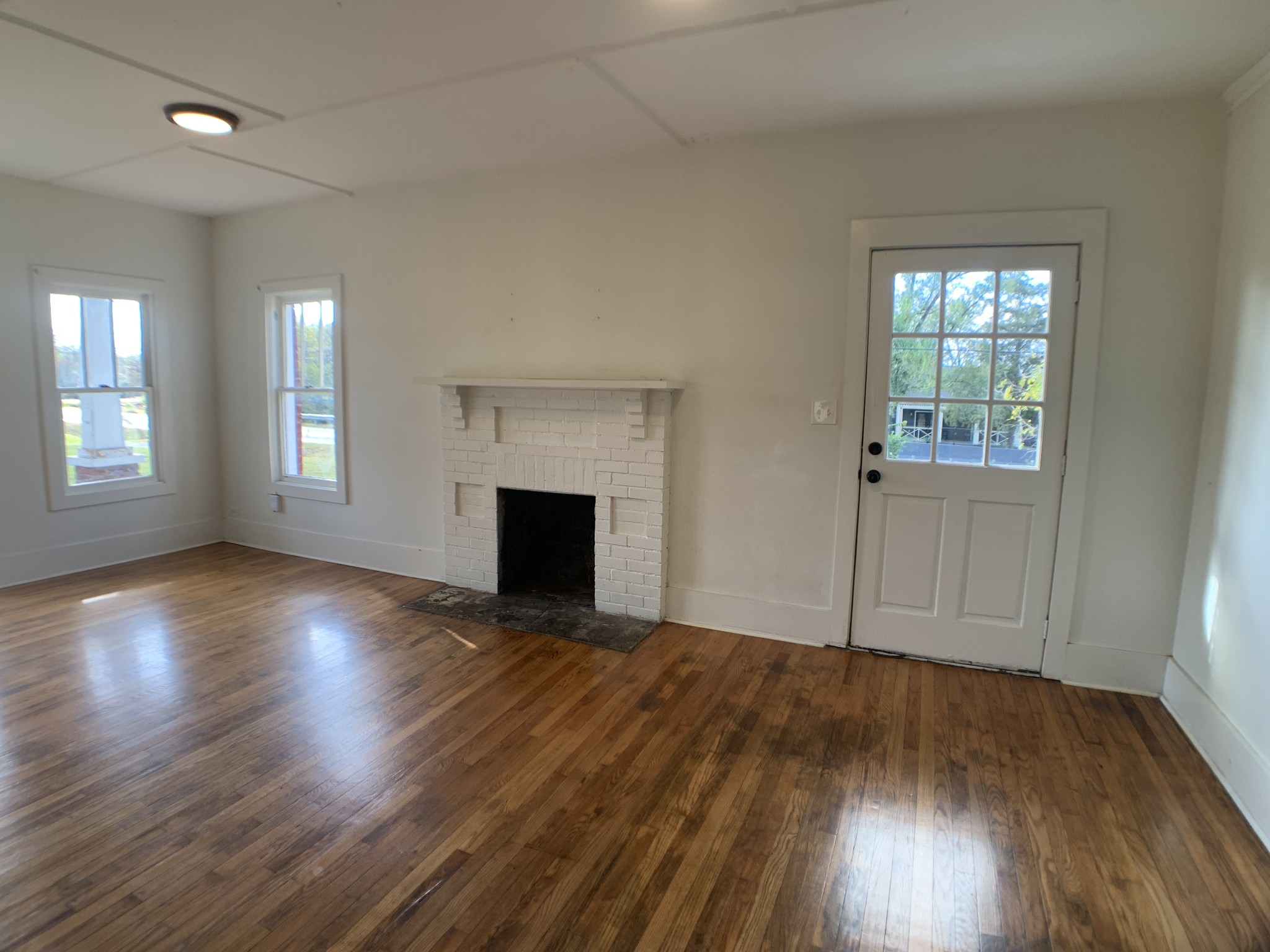 563 Neelys Bend Road Madison, TN 37115 - Photo 3 of 13 an empty room with wooden floor and windows