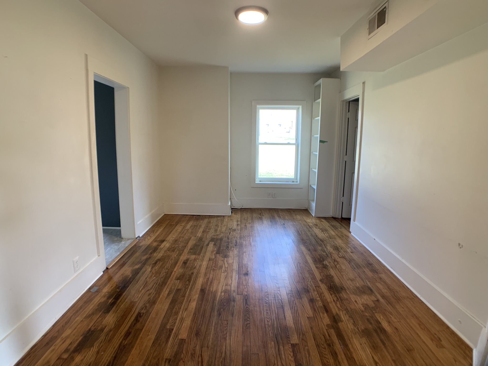 563 Neelys Bend Road Madison, TN 37115 - Photo 5 of 13 an empty room with wooden floor and windows