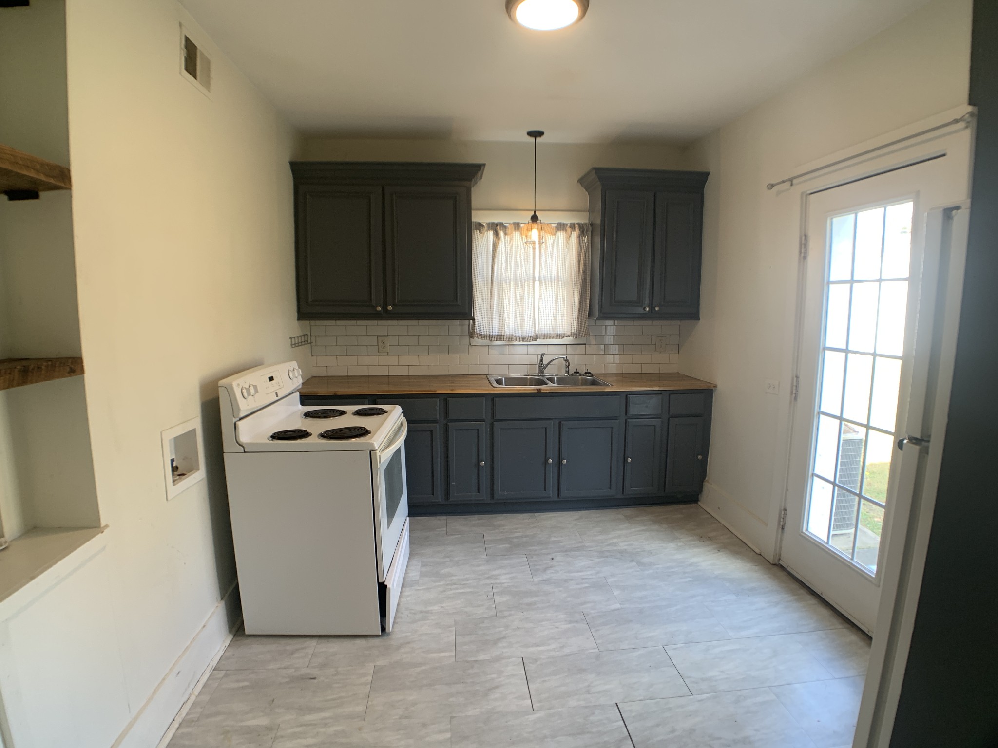563 Neelys Bend Road Madison, TN 37115 - Photo 6 of 13 a kitchen with a stove a sink and a refrigerator