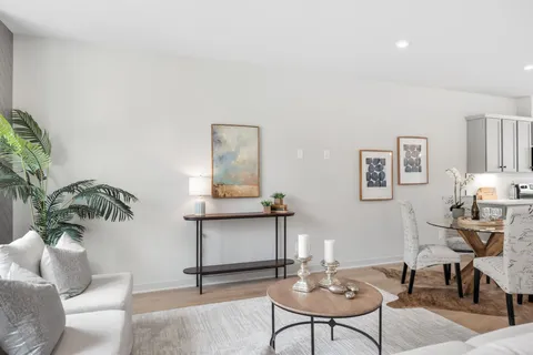 a kitchen with kitchen island granite countertop a sink a counter space appliances and cabinets