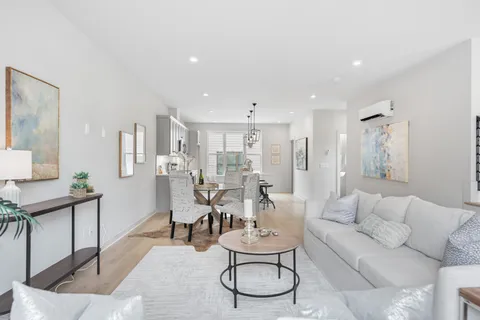 a kitchen that has a lot of cabinets furniture and appliances