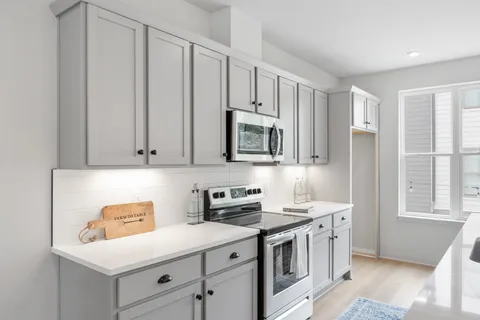a kitchen with counter top space appliances and cabinets