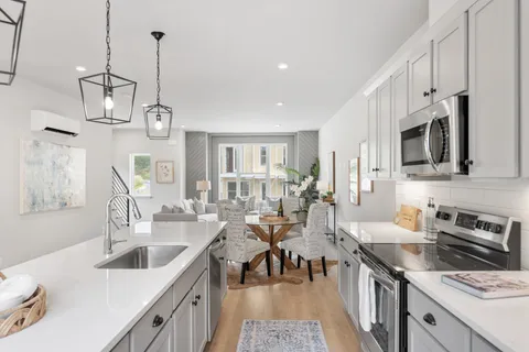 a kitchen with stainless steel appliances a stove a sink and cabinets