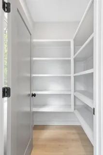 a bedroom with a bed and a potted plant