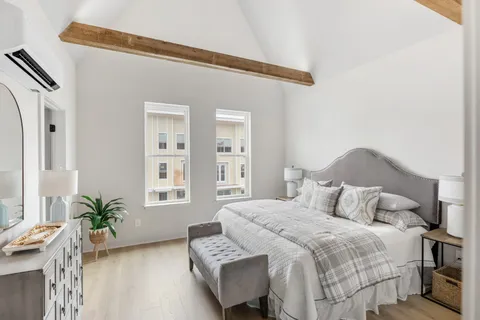 a bedroom with a bed and a potted plant